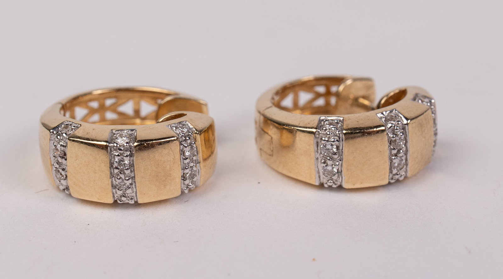 14KY Gold Huggie Hoop Earrings: Marked "585", Total weight 5 grams Literature Brooks Auction – Online Auction Terms & Conditions Contact: (856) 694-2960 | info@brooks.auction READ BEFORE YOU BID: We want you to feel confident
