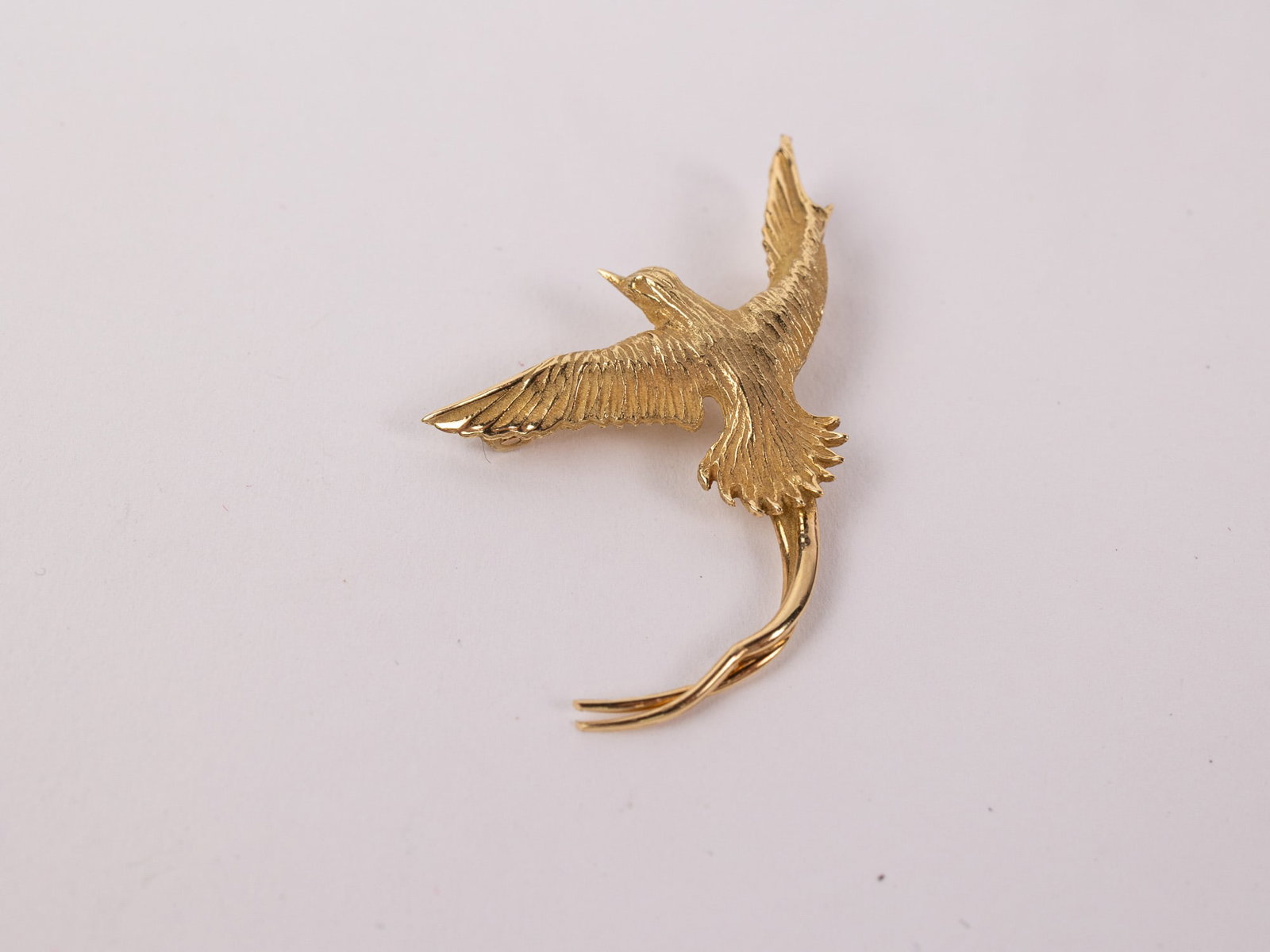 18KY Gold Astwood Dickinson Bermuda Longtail Brooch: Marked "18ct", Total weight is 3.7 grams Literature Brooks Auction – Online Auction Terms & Conditions Contact: (856) 694-2960 | info@brooks.auction READ BEFORE YOU BID: We want you to feel