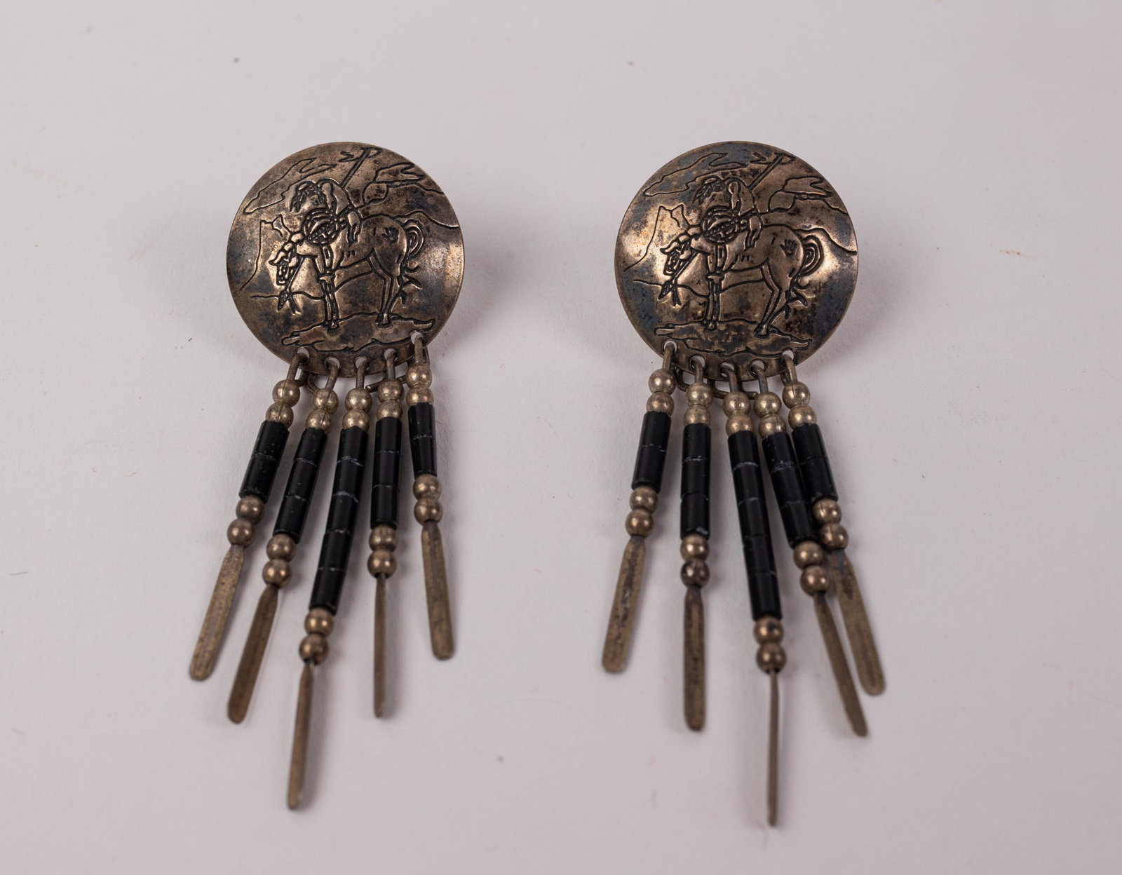 Native American Quock Turquoise Sterling Earrings w/ "End of the Trail" Motif: Marked "Q.T. Sterling", Total weight is 5.5 grams Literature Brooks Auction – Online Auction Terms & Conditions Contact: (856) 694-2960 | info@brooks.auction READ BEFORE YOU BID: We want you to