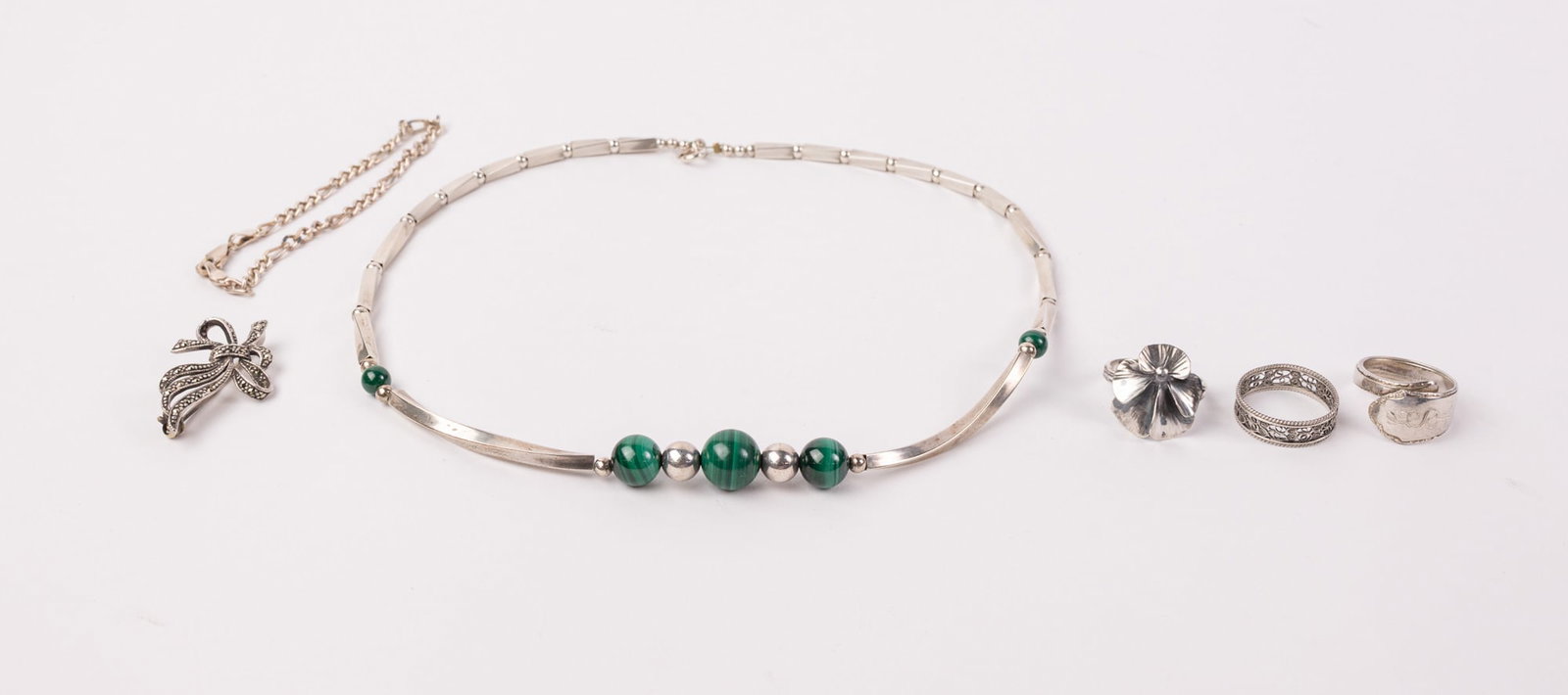 Grouping of Assorted Silver Jewelry ft. Malachite Necklace: Markings: "Sterling" "925" & "800", Total weight is 42.2 grams Literature Brooks Auction – Online Auction Terms & Conditions Contact: (856) 694-2960 | info@brooks.auction READ BEFORE YOU BID: We
