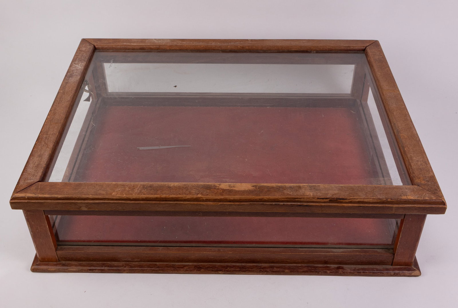 Vintage Wood Display Case with Red Backing: missing left and right side panels of glass Size 6" x 23" x 18" Literature Brooks Auction – Online Auction Terms & Conditions Contact: (856) 694-2960 | info@brooks.auction READ BEFORE YOU BID: