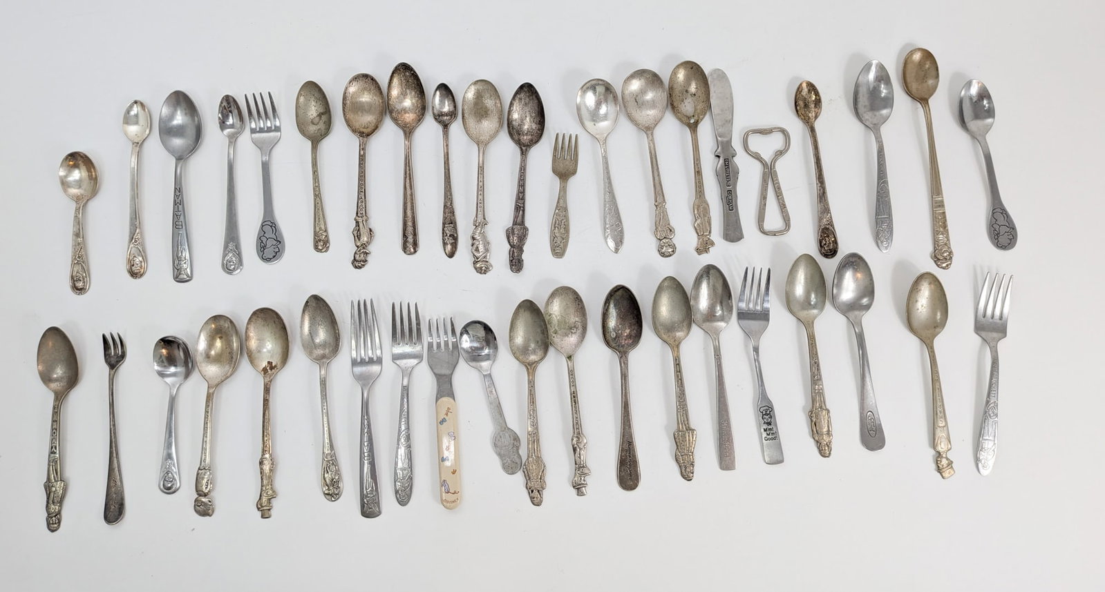 Grouping of Vintage Character and Advertising Spoons ft. Disney: Silver Plated and Stainless Size 7" x 12" x 12" Literature Brooks Auction – Online Auction Terms & Conditions Contact: (856) 694-2960 | info@brooks.auction READ BEFORE YOU BID: We want you to