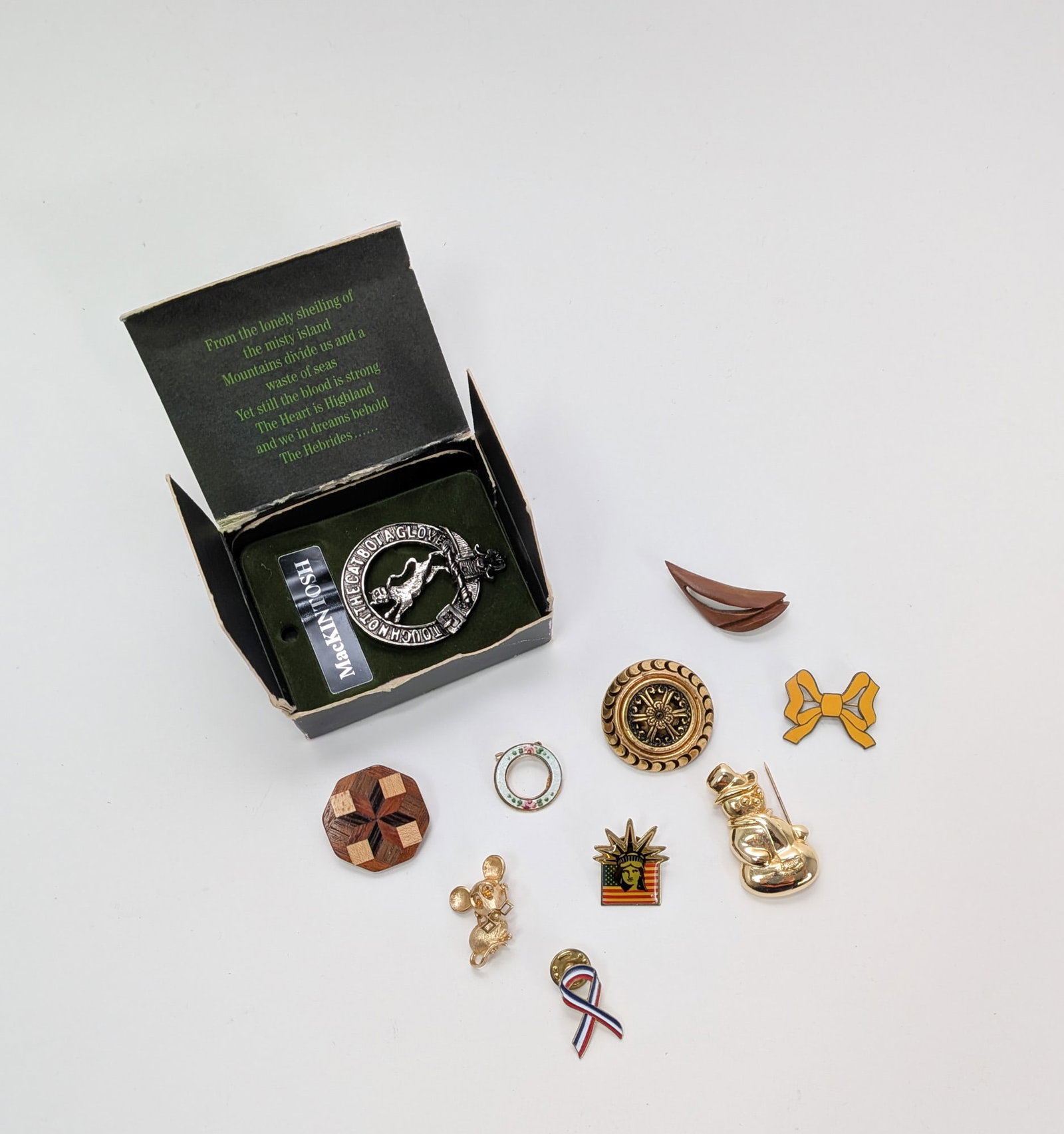 Assortment of Pins and Brooches ft. Octagonal Wooden Mosaic Brooch: Assortment of Pins and Brooches ft. Octagonal Wooden Mosaic Brooch Size 7" x 12" x 12" Literature Brooks Auction – Online Auction Terms & Conditions Contact: (856) 694-2960 |