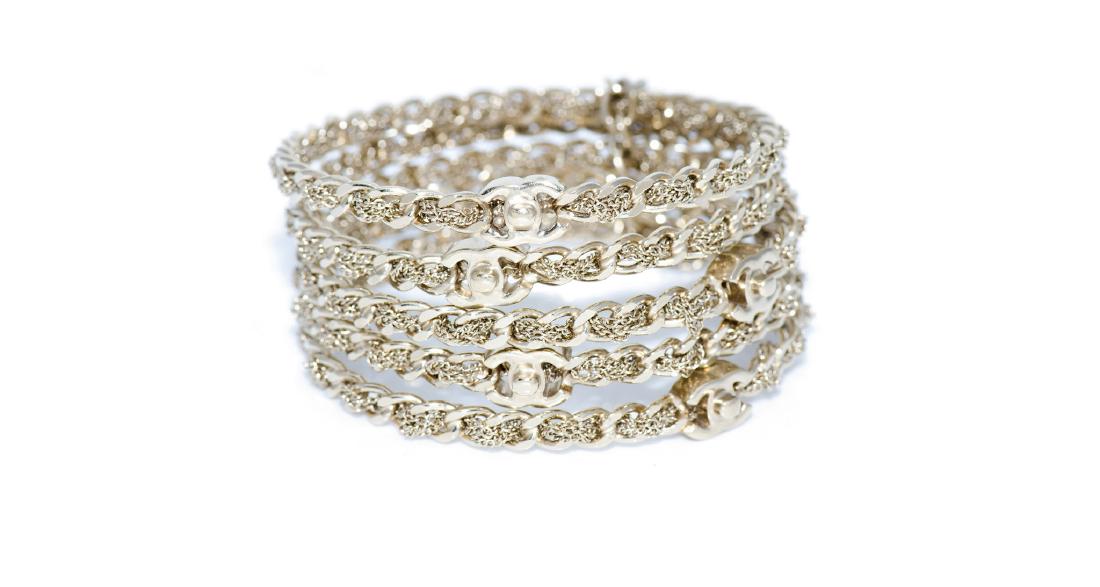 Chanel Interlaced Chain Bracelets, Interlocking CC Logo: Jewelry: Chanel Interlaced Chain Bracelets with Interlocking CC Logos Metal: Yellow Alloy Condition: Very Good - Minor scratching on metal Markings: ©Chanel® P logo, Made in Italy Appraised Period: