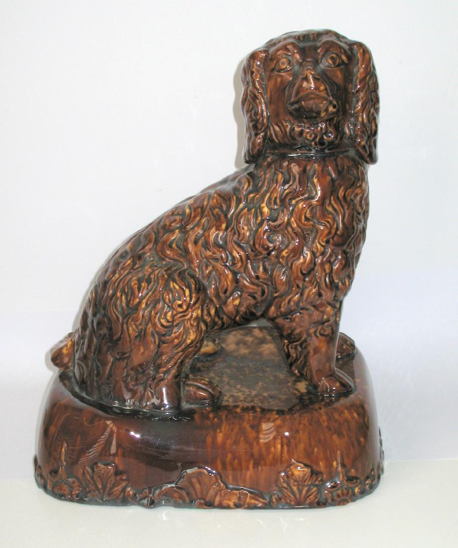 Seated Pottery Dog: Item: Large size Rockingham or yelloware seated pottery dog. Date: Circa 1890's. Size: 12 inches tall Please note that this lot has a confidential reserve. When you leave a bid in advance of the aucti