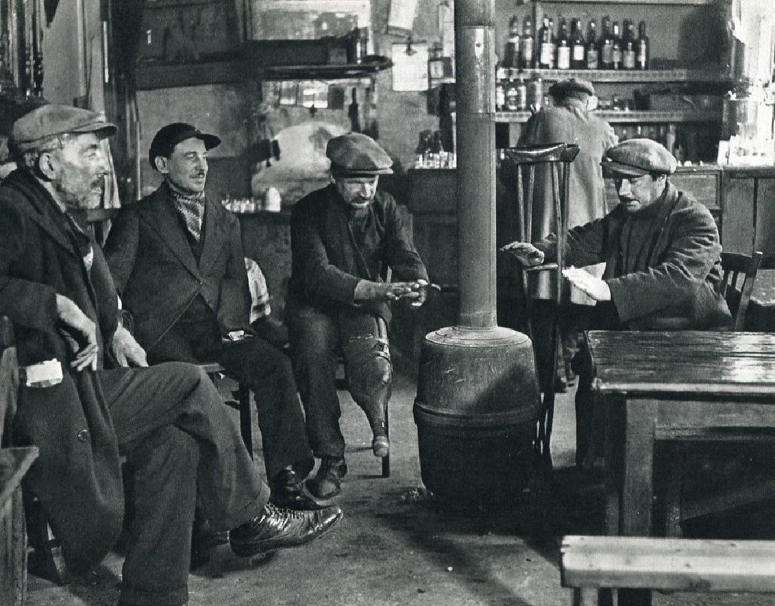 ANDRE KERTESZ: In a Bistro, 1927 Paris: Print Title: In a Bistro, 1927 Paris Artist: Andre Kertesz Medium: Sheet-Fed Gravure Printing Date: 1972 Maker: Braun - Mulhaus, France Image Size: 9 x 7 inches Andre Kertesz, born Kertesz Andor, was