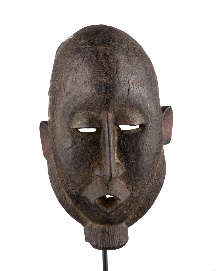 Dogon Mask, Mali: Although this mask is more rounded than traditional Dogon sculpture, the angular nose and beard allow for it to be attributed to the Dogon. It is made from a very hard and dense wood with sign of use