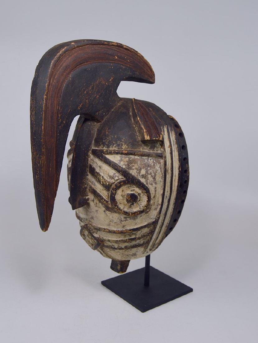 Fantastic Winiama African mask with Raised Crest: The mask face is classic for the Winiama peoples and features widely spaced "target" eyes, a hooked nose, tab ears, a wide open mouth showing upper and lower teeth, and, below the chin, a handle by wh