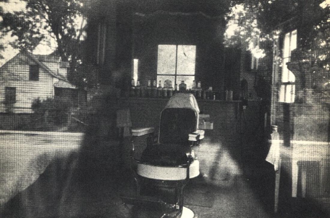 ROBERT FRANK: Barbershop, McClellanville, S.C: Artist: ROBERT FRANK Print Title: Barbershop through Screen Door, McClellanville, S.C Medium: Vintage Sheet-fed Gravure Printed in 1958 in France Image Size: 7.5 x 5 inches Robert Frank (b. 1924) is a