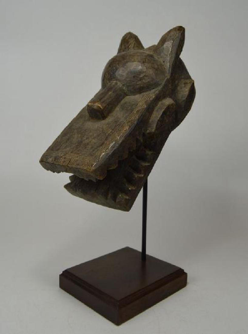 Toma Miniature Helmet Mask: A Small Carved wooden helmet mask with agressive rows of teeth and stylized ears and horns. This mask was not worn, but perhaps served as a clan totem. From the Toma peoples of Guinea, West Africa. Th