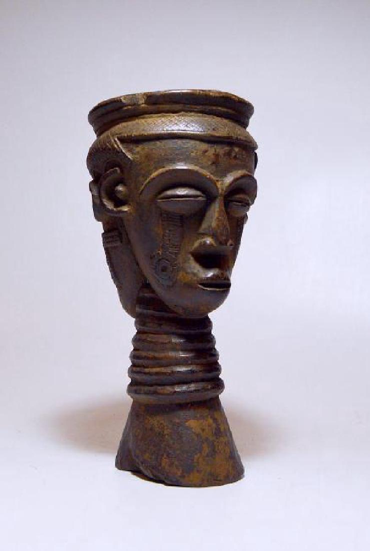 Old Kuba Janus Palm Wine Cup: This is a very nice old Palm wine cup from the Kuba peoples of the Congo, Africa. Ornate vintage to antique cup featuring two ancestor heads in janus form and a well handled surface suggesting years o