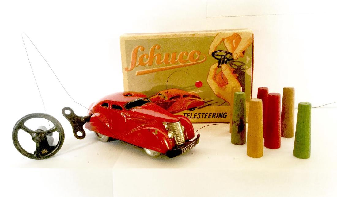 Telesteering Tin Toy CAR Wind Up by SCHUCO: Telesteering Tin Toy CAR Wind Up by SCHUCO Painted Tin Car with painted Wood Cones for Race Course, Original Box and Key, Excellent Working Condition Made in Germany by Schuco, 1930's Car Measures 1 1