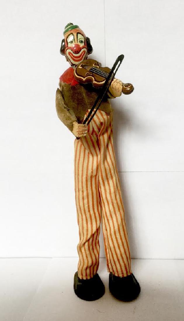CLOWN Playing Violin Wind Up Toy: CLOWN Playing Violin Wind Up Toy Tin Litho with Velvet and Cotton Clothing, Works Japan, C. 1050's 8 3/4" tall x 2 1/4" wide x 3 1/2" deep Please note that this lot has a confidential reserve. When yo
