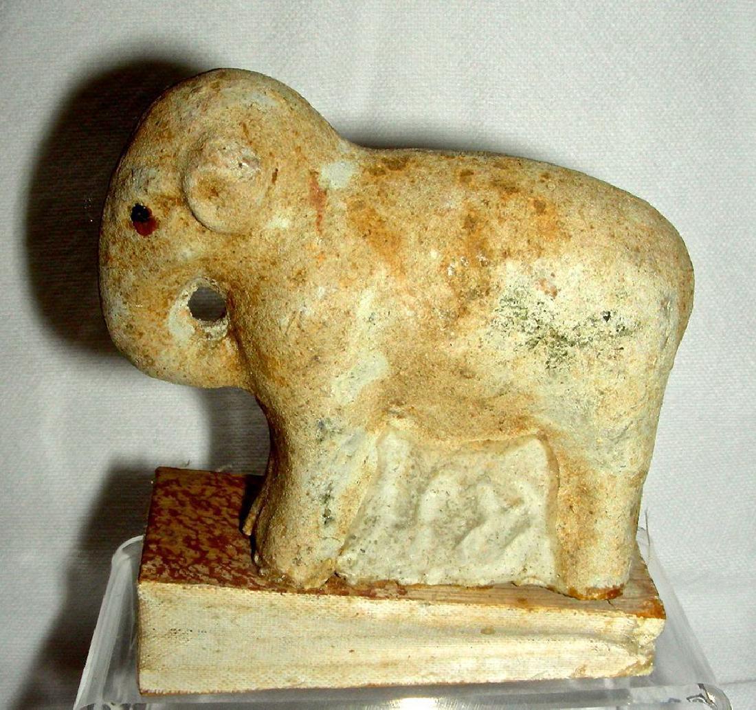 Papier Mache Elephant Squeak Toy, 20th Century: A very small, composition (probably Papier Mache) squeak toy in the form of a standing Elephant. Base is wood and cloth. The toy is about 3 ½” tall and the base measures 2 ¾” x 1 3/8”. Everyth