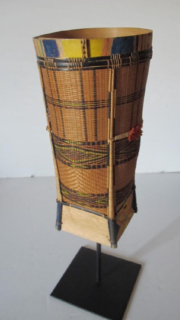 Balinese Elongated Basket: Balinese Elongated Basket. Collected in the 1960's this is an elongated basket from Bali. Composed of reeds/string and pigments. Weaving on the base is is intricate. 12" 1/2 tall x 6 1/4" diameter. Ha