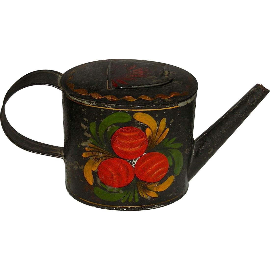 Decorated Toleware (Tin) Teapot, c. 1840-1860: A rare form in decorated toleware: an oval teapot dating to the mid 19th century – c. 1840-1860. The teapot is decorated in reds, oranges, green and yellow, and each side includes 3 round fruits, wi