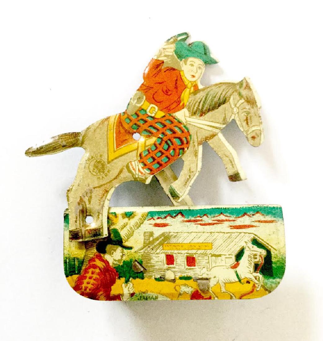 Tin Litho Cowboy Clicker Toy: Tin Litho Cowboy Clicker Toy Trademark is an Indian Head Japan, 1950's 3 1/8" tall x 2 7/8" wide x 1/2" deep Please note that this lot has a confidential reserve. When you leave a bid in advance of th