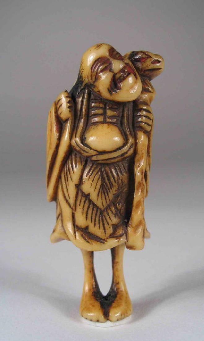 Edo Period Staghorn Netsuke, Gamma Sennin with Frog: A Japanese staghorn netsuke in the form of the beloved Gamma Sennin (Liu Hai in Chinese lore) carrying a large frog on his back and holding his staff in his left hand. With pleasant expression, bare f