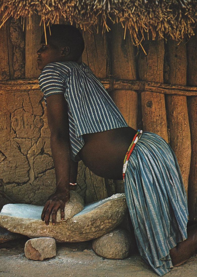 EMIL SCHULTHESS - Grinding Millet in Siamapumba,: Artist: EMIL SCHULTHESS Print Title: Grinding Millet in Siamapumba, Rhodesia - a method still in use since the Stone Age Printing Date: 1958 Medium: Sheet-fed Gravure Printed in Switzerland Image Size