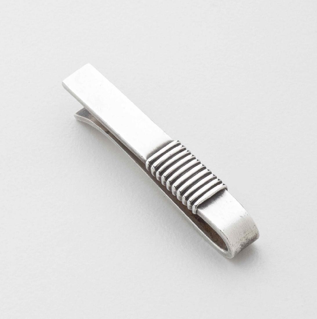 Georg Jensen Harald Nielsen Sterling Silver Tie Bar: Georg Jensen Sterling Silver Tie Bar No. 52B. This sterling silver tie bar was designed by Harald Nielsen. The tie bar measures 1.55 inches long and .25 inches wide. The tie bar bears impressed compan