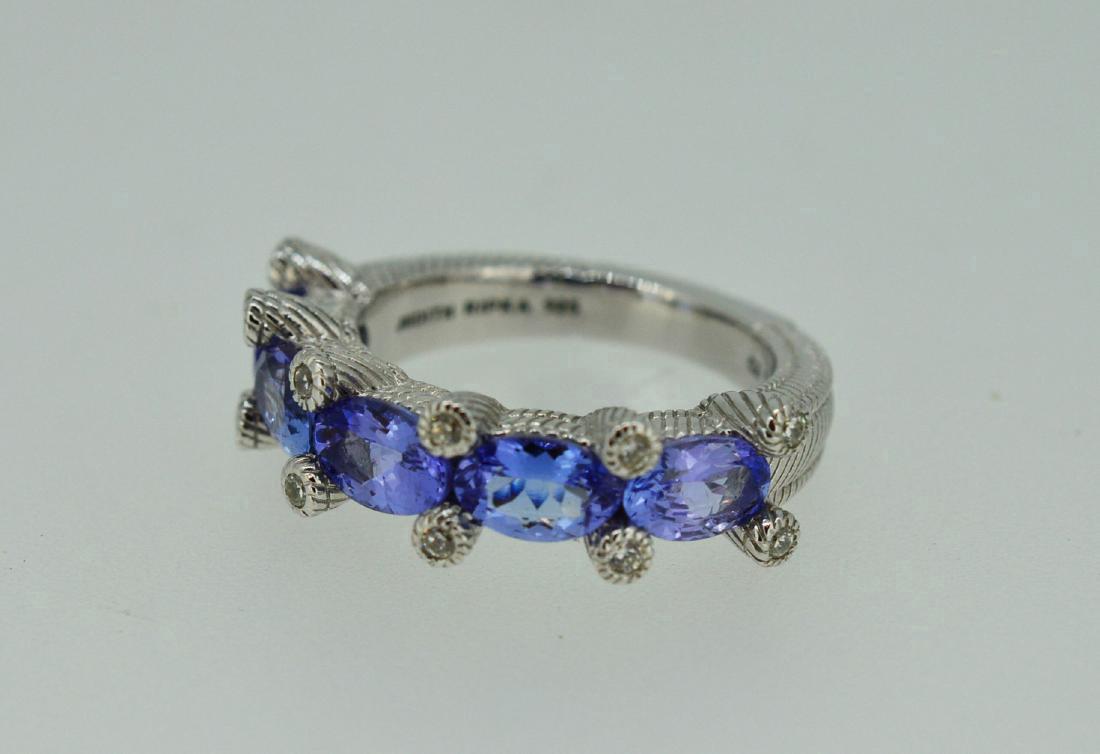 Blue Topaz and Sterling Silver Ring: ring with 5 intense blue stones 2 ct tw blue topaz, 3.4 Dwt tw size 5 3/4" by designer judith ripka Please note that this lot has a confidential reserve. When you leave a bid in advance of the auction