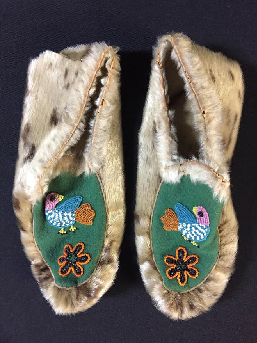 1920's Eskimo Seal Skin Beaded Moccasins: 1920's Eskimo seal skin beaded moccasins. There are some small holes on the skin around the rim (opening). Great condition. Dimensions: About 10" across. Please note that this lot has a confidential r