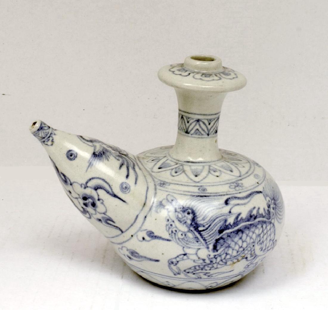 Vietnamese B & W Porcelain Kendi with Mammary Spout: Vietnamese Blue and white porcelain kendi, ki-lin motif with a bulbous body, tall, narrow neck, flange around the mouth and a mammary spout. HIGH: 7 inches WIDTH: 8 inches Please note that this lot ha