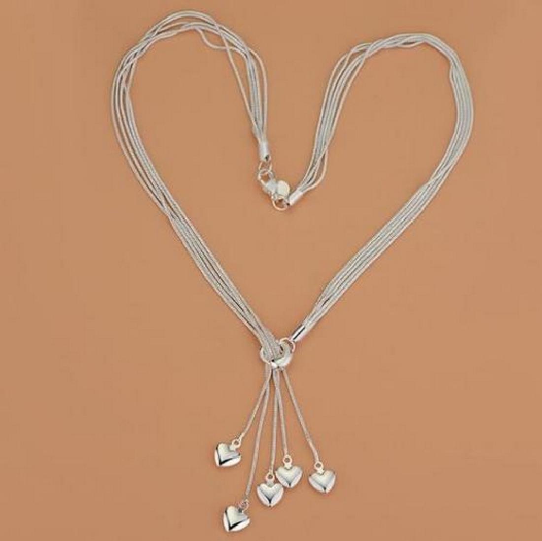 Sterling Silver Tassel Hearts Necklace: .925 Sterling silver tassel hearts necklace. 17 inches. Please note that this lot has a confidential reserve. When you leave a bid in advance of the auction, submit your maximum. Jasper52 will bid on 