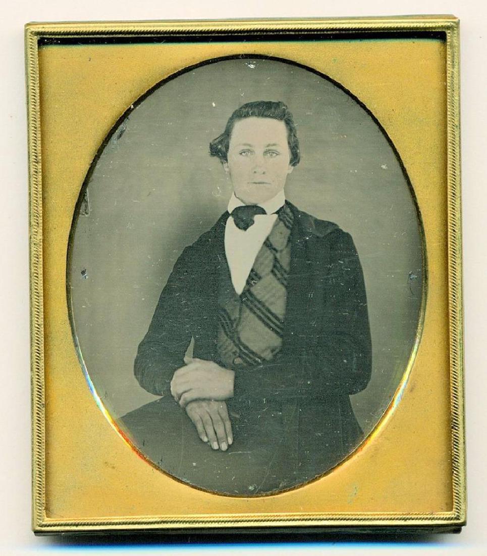1850s Daguerreotype #31 Ethereal Young Man: Circa 1850s sixth plate daguerreotype depicting an ethereal looking young man who appears to be almost floating in front of the contrasting stark plain background. Lighting created an odd looking "