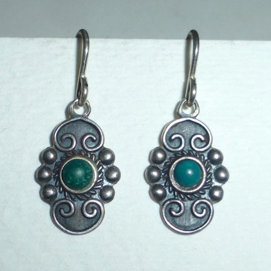 Vintage Mexican Sterling Silver Turquoise Drop Earrings: A sweet pair of vintage Mexican sterling and turquoise earrings c1940s. Round turquoise cabs are bezel set in the center and framed with twisted wire. Applied wire curls embellish above and below the