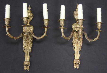 Pair of Three-Armed French Bronze Sconces: Pair of Three-Armed French Bronze Sconces. Lovely pair of cast bronze sconces with a nice patina: top flame and urn with decorative leaf body and central bow decoration descending to another bow,