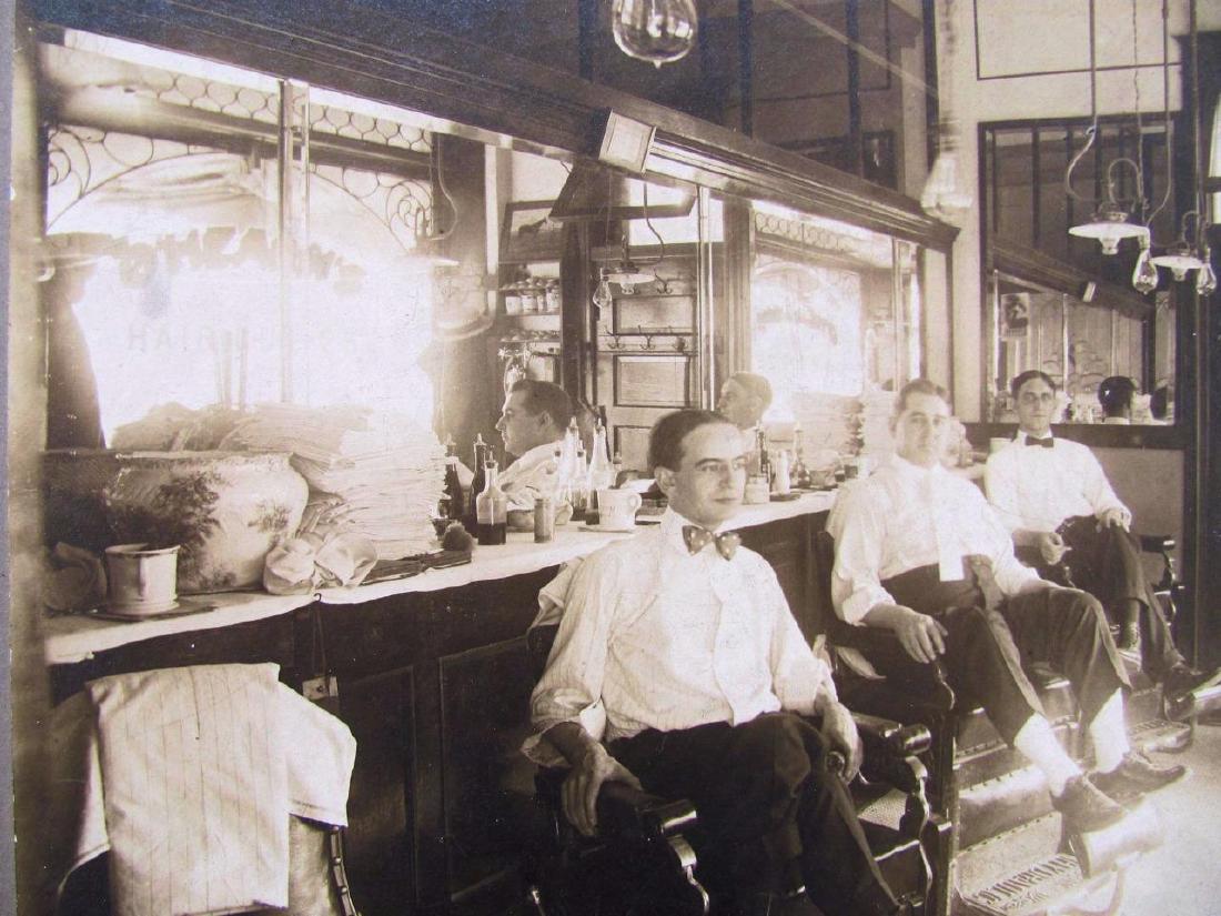 1900 Barber Shop Interior O'hearns Haircuts Kansas: Circa 1900 Antique Occupational Photograph on Board; Depiction of the interior of a barber shop with three workers sitting in the barber chairs. Visible in the mirror is text which reads; O'HEARN'S HA