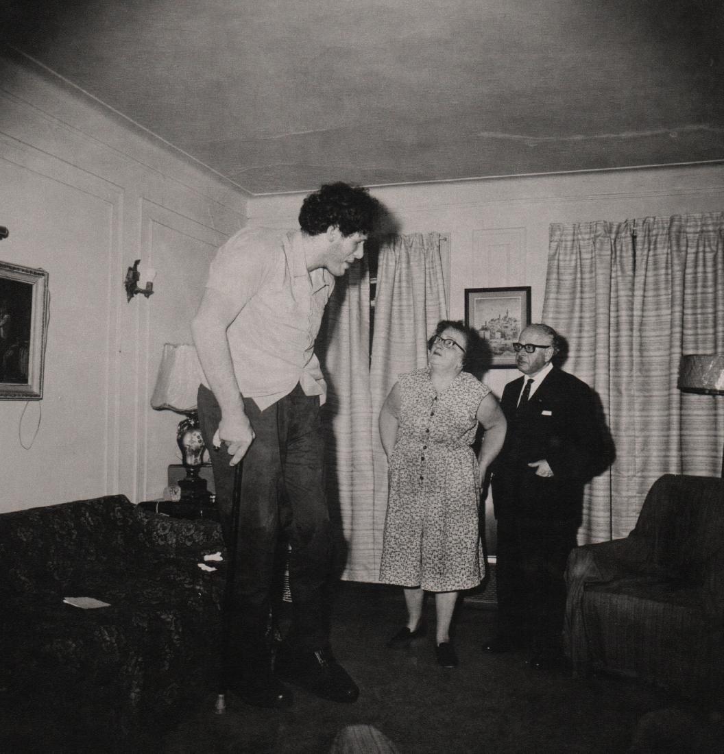 DIANE ARBUS - Jewish Giant 1970: Artist: DIANE ARBUS Print Title: Jewish Giant at home with his parents in The Bronx, NY 1970 Medium: Medium: Gravure Printed in Italy Printing Date: 1979 Image Size: 9.75" x 10" Diane Arbus was an Ame