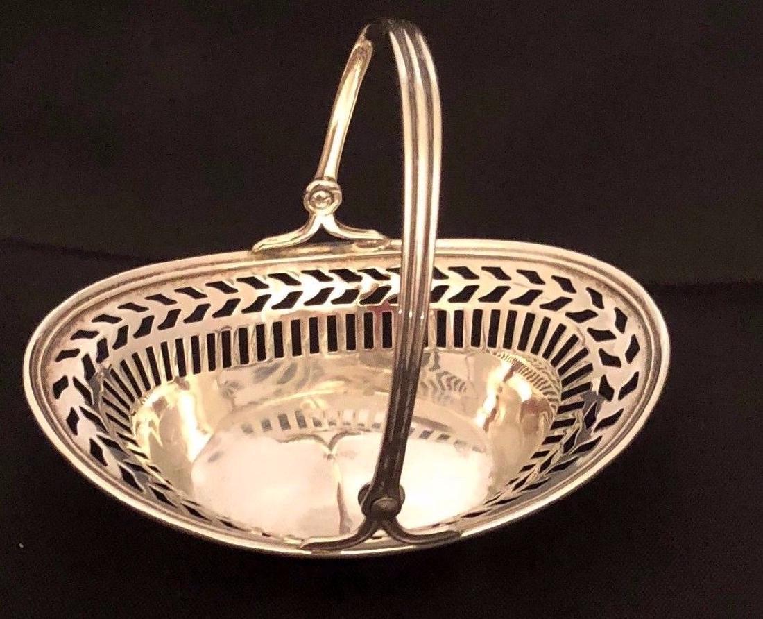 Antique American Watson Sterling Silver Basket: Small Sweetmeats basket in Sterling Silver. Made by the Watson Company out of Attleboro, Massachusetts. Date range is 1915-1955. 3"x2 1/4. handle is 3" tall from bottom. 0.09 oz Please note that this 