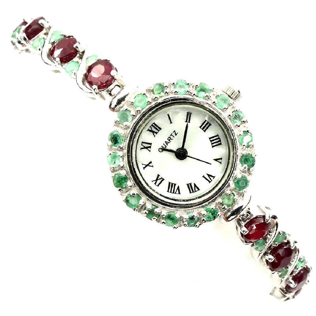 Platinum Sterling Silver Emerald Ruby Watch, 9.64ctw: Item: 9.64 carat Genuine Emerald & Ruby Watch Metal Purity: Platinum over Sterling Silver Gemstones: Emerald & Ruby Carat Weight: 9.64 No Brand Name, States "Quartz' on Face, Rubies are enhanced by fi
