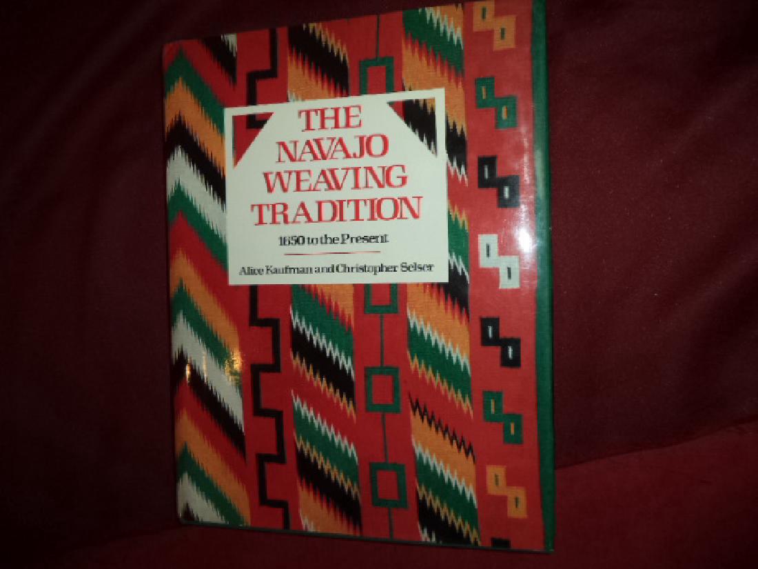 Navajo Weaving Tradition. Inscribed by the authors: The Navajo Weaving Tradition. Inscribed by the authors. 1650 to the Present. Kaufman, Alice & Christopher Selser. E.P. Dutton. First edition. 4to. Illustrated. Important reference work. Inscribed by t