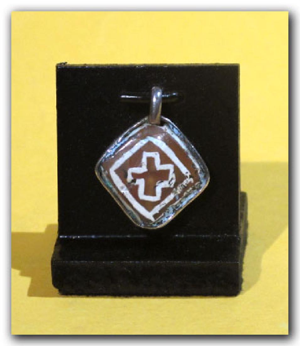 Byzantine Silver and Etched Cornelian Pendant: Byzantine Silver and Etched Cornelian Pendant, c. 5th-6th Century A.D. Dimensions: 2.4 cm L (including loop) - 15/16” Material: Silver and cornelian Origin: Byzantine, c. 5th-6th Century A.D. Proven