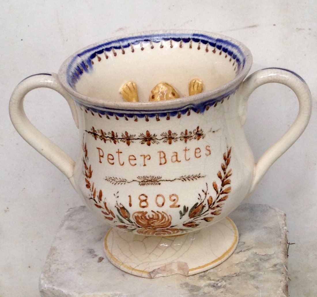 Creamware Frog Cup Dated 1802: Dated 1802 creamware frog cup. One base chip, some crazing, otherwise VGC. No repairs. 5"high. 7" wide handle to handle. Shipping: Domestic: Flat-rate of $20.00 to anywhere within the contiguous U.S.