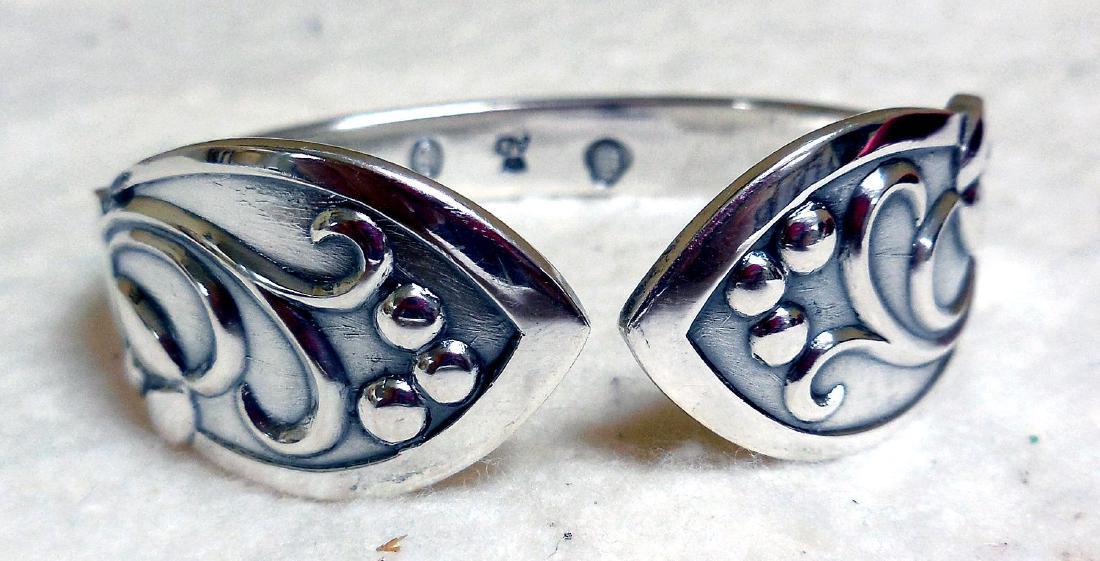 Mid-Century Danish 826 Silver Napkin Ring, Signed: Item: Danish Silver Napkin Ring, Signed Maker/Designer: Unknown Origin: Denmark Date/Period: Ca 1950 Silver Purity: 0.826 Size: 1 3/4 Inches wide, 5/8 inch thick Item Weight: 21.0 grams Hallmarks: Dan