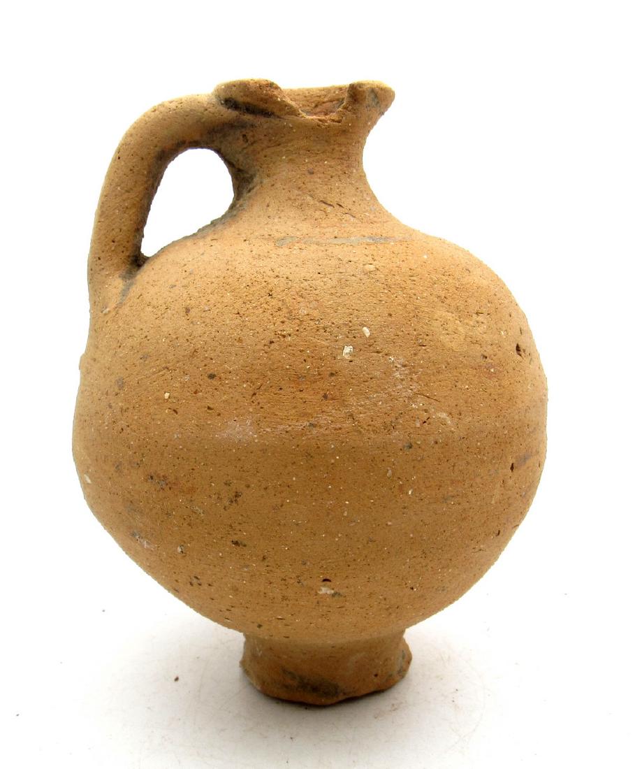 Ancient roman terracotta wine jug with handle: Date: Circa 200 A.D. Material: terracotta Provenance: Purchased from an old German collection, purchased in Munich Dimensions: 83x109mm; 194.3grams Ancient roman terracotta wine jug with handle. Super