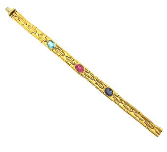 Bvlgari 18K Gold Topaz Tourmaline Sapphire Bracelet: Bvlgari 18k Yellow Gold, Topaz, Tourmaline & Sapphire Bracelet. This is a must for a collector. The weight is 49.6 grams. The length is 7 ¼ inches. The height is 5/16 of an inch. The width is