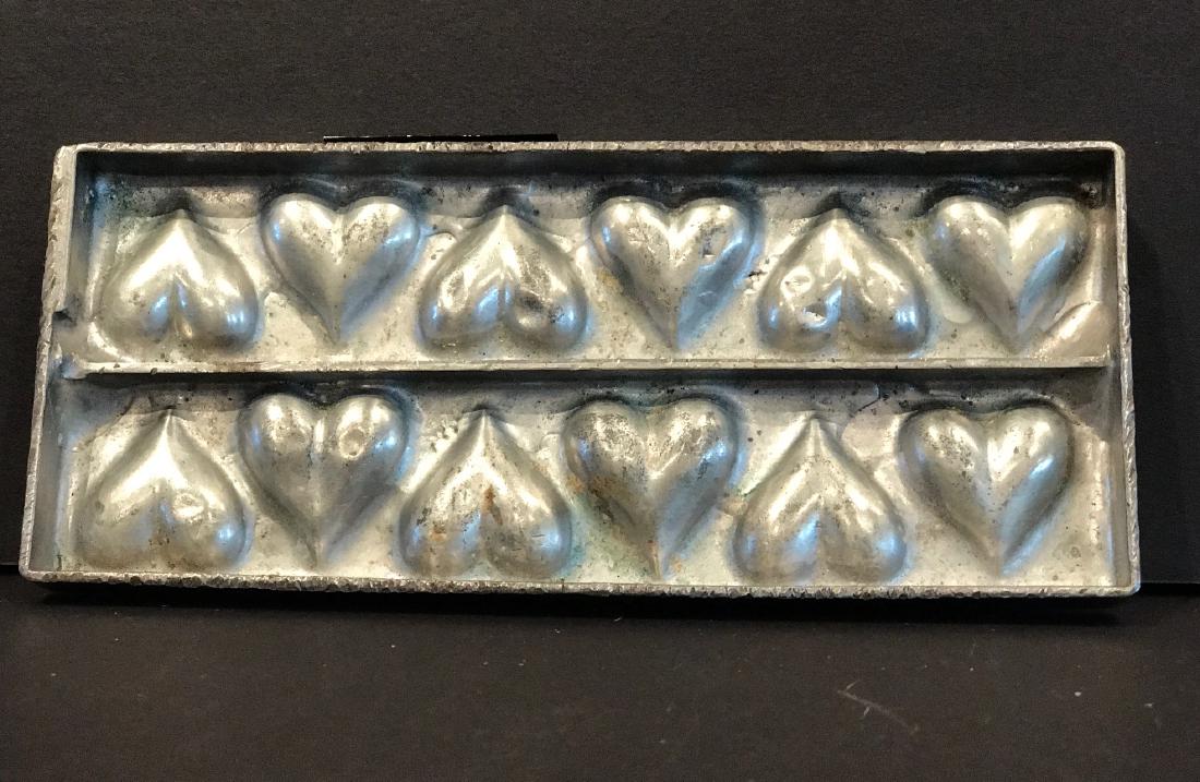 Twelve Heart “Flattie” Chocolate Mold, C. 1920: Twelve heart “flattie” chocolate mold, c. 1920 Anton Reich, well-known German maker. Diminutive. (May be wall-mounted with a pot magnet). 3 h x 7 1/3 w c. 1920 Shipping: Domestic: Flat-rate of $30
