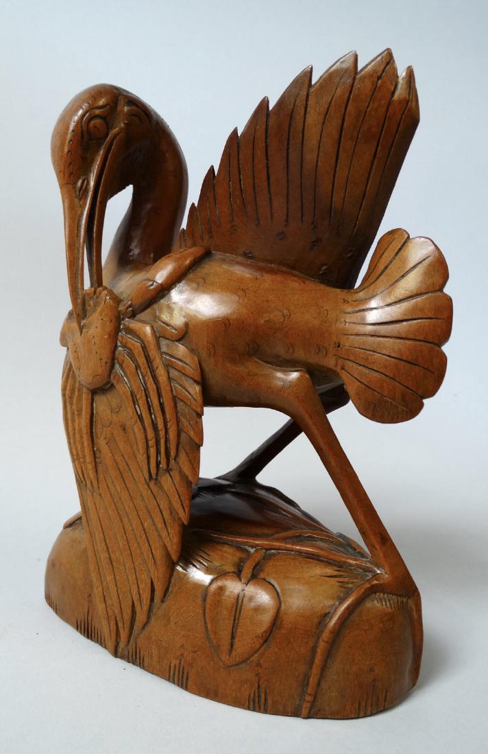 Art Deco style woodcarving bird eating a crab: Origin: Bali – Indonesia Date: Mid 20th century Materials: Wood Size: 15 x 12 x 6,8 cm Woodcarving from Bali. It represents a large bird eating a crab. Carved in the sought-after Art Deco style. The