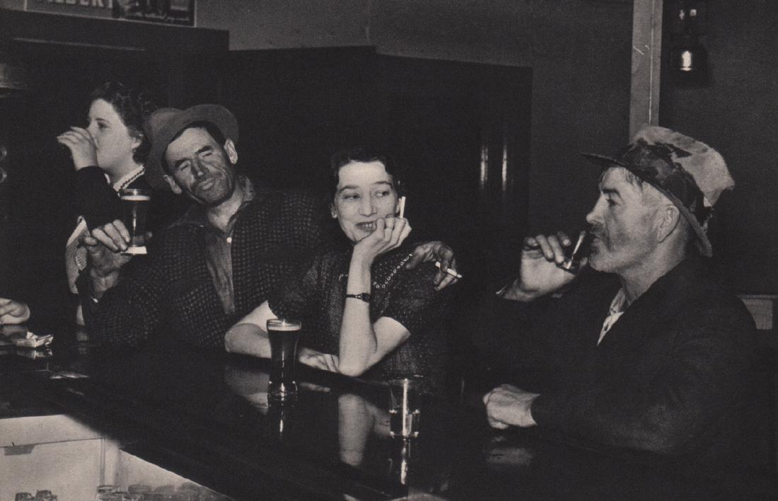RUSSELL LEE - At the Bar, FSA image: Artist: RUSSELL LEE Print Title: At the Bar, FSA image Medium: Sheet-fed Gravure Printing Date: 1936 Printing Location: USA Image Size: 8 x 5.25 inches Russell Lee (1903-1986) was an American photogra