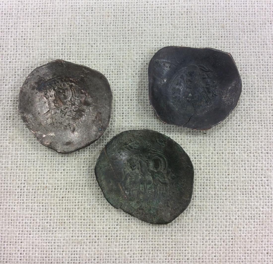 Byzantine Empire Cup Shaped Scyphate Coins: Byzantine Empire Cup shaped Scyphate Coins 100-1300's AD Mixed Metal Set of 3 Please note that this lot has a confidential reserve. When you leave a bid in advance of the auction, submit your maximum.