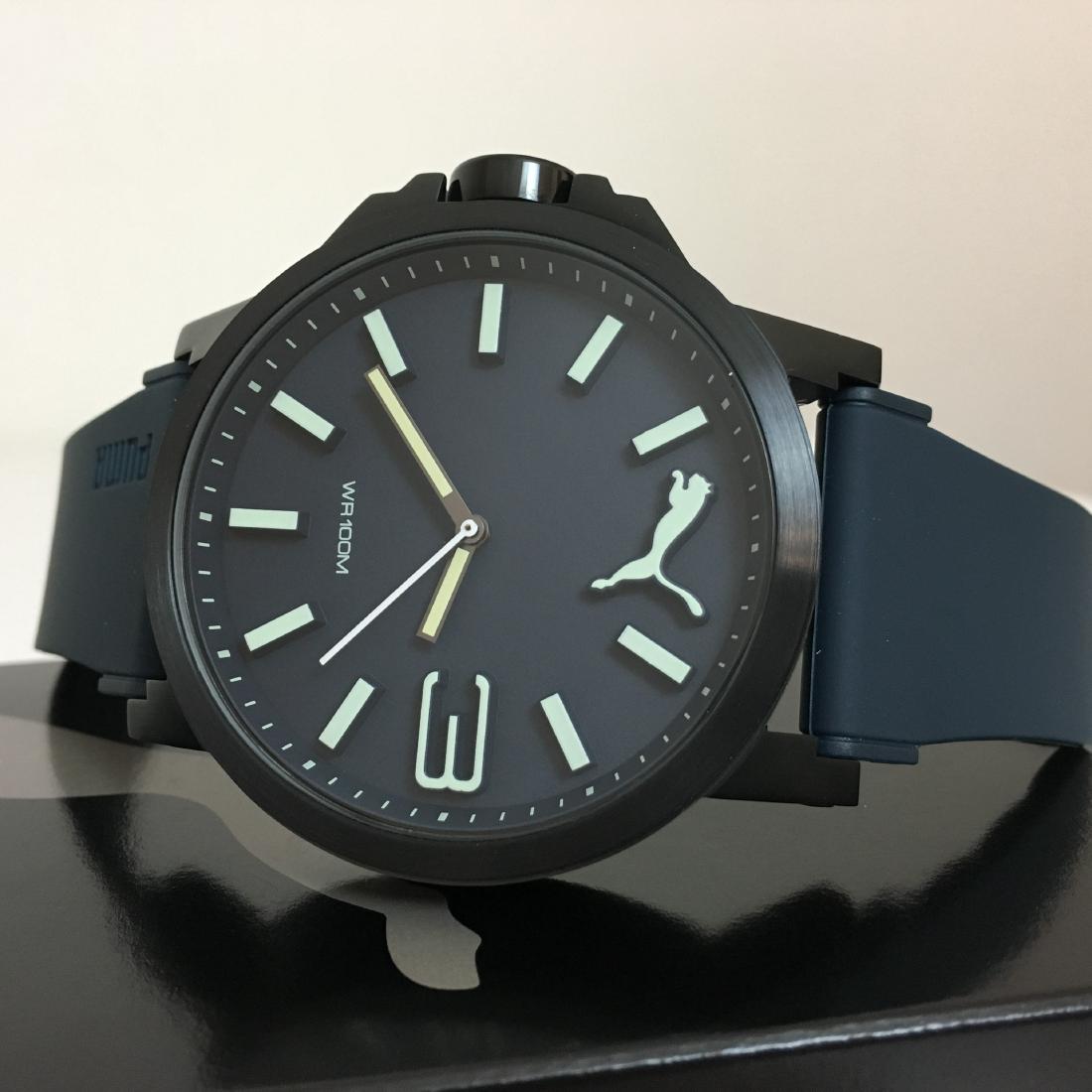 PUMA Ultrasize 50 - Luminous Watch – New With Box: Japanese quartz movement. Scratch resistant: Mineral crystal. Water resistant: 100 meters / 330 feet. Case diameter: 50 mm Standard 184mm-197mm Quartz Please note that this lot has a confidential rese