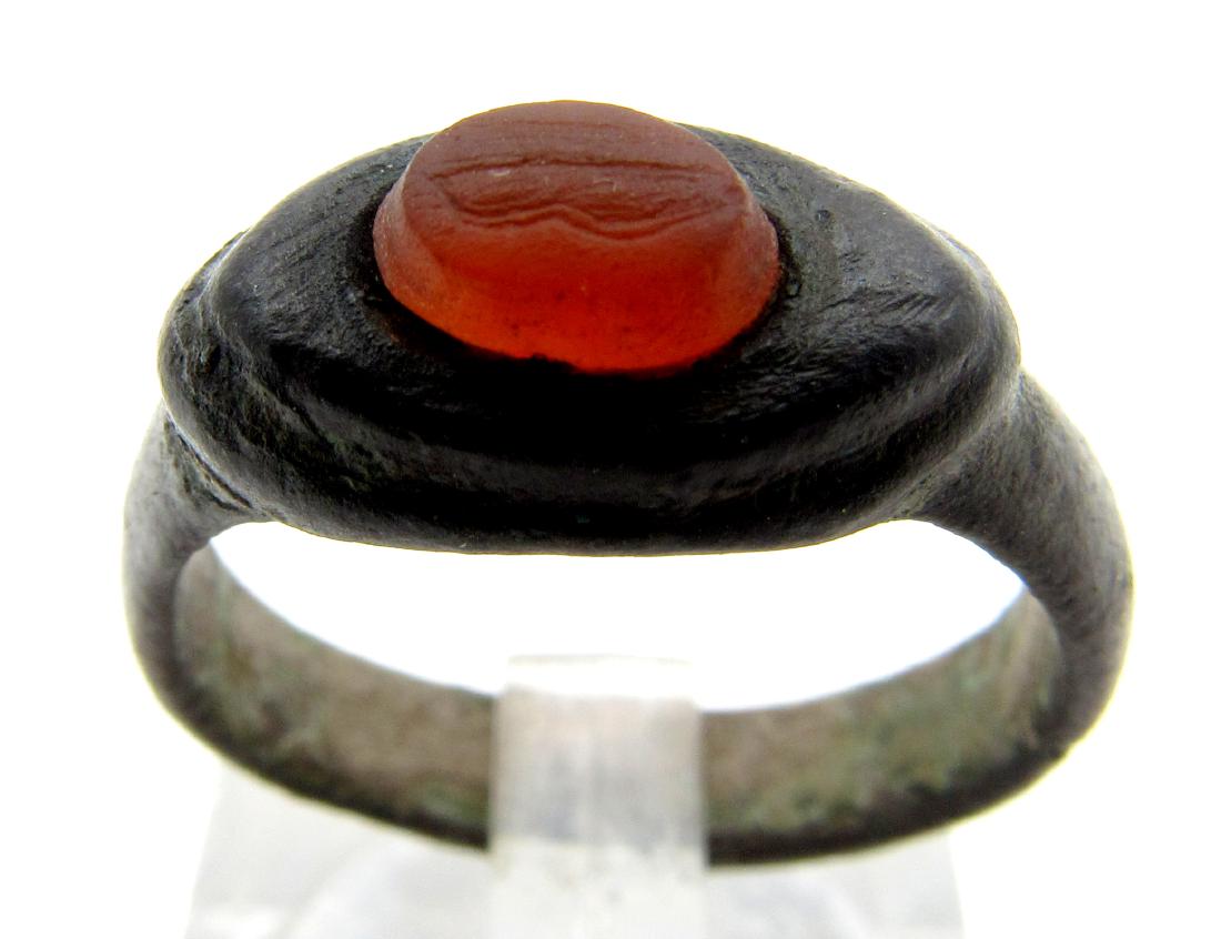 Ancient Roman Intaglio Carnelian Stone with Symbol: Material: bronze Provenance: Obtained from an old British collection; Acquired at L.C.F. (London) Dimensions: 17mm; 4.9grams Ancient Roman intaglio carnelian stone carved with a mysterious symbol. Pro