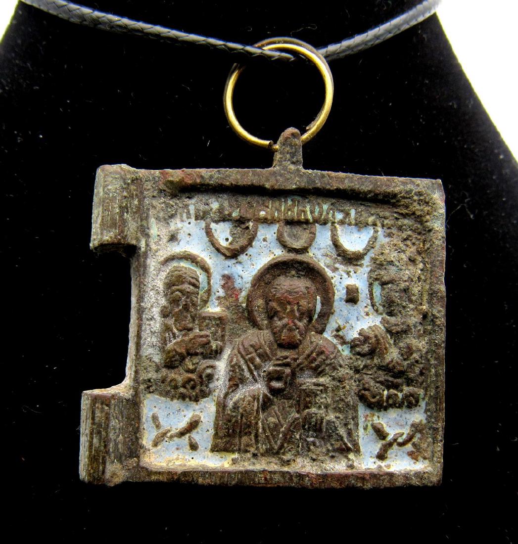 Medieval Enameled Icon with St. Nicholas: Date: 9th - 15th C. AD Material: bronze Provenance: Obtained from an old British collection, acquired from the B.C.F. (Birmingham) Dimensions: 32mm; 15.3grams Medieval Enameled Icon with St. Nicholas 
