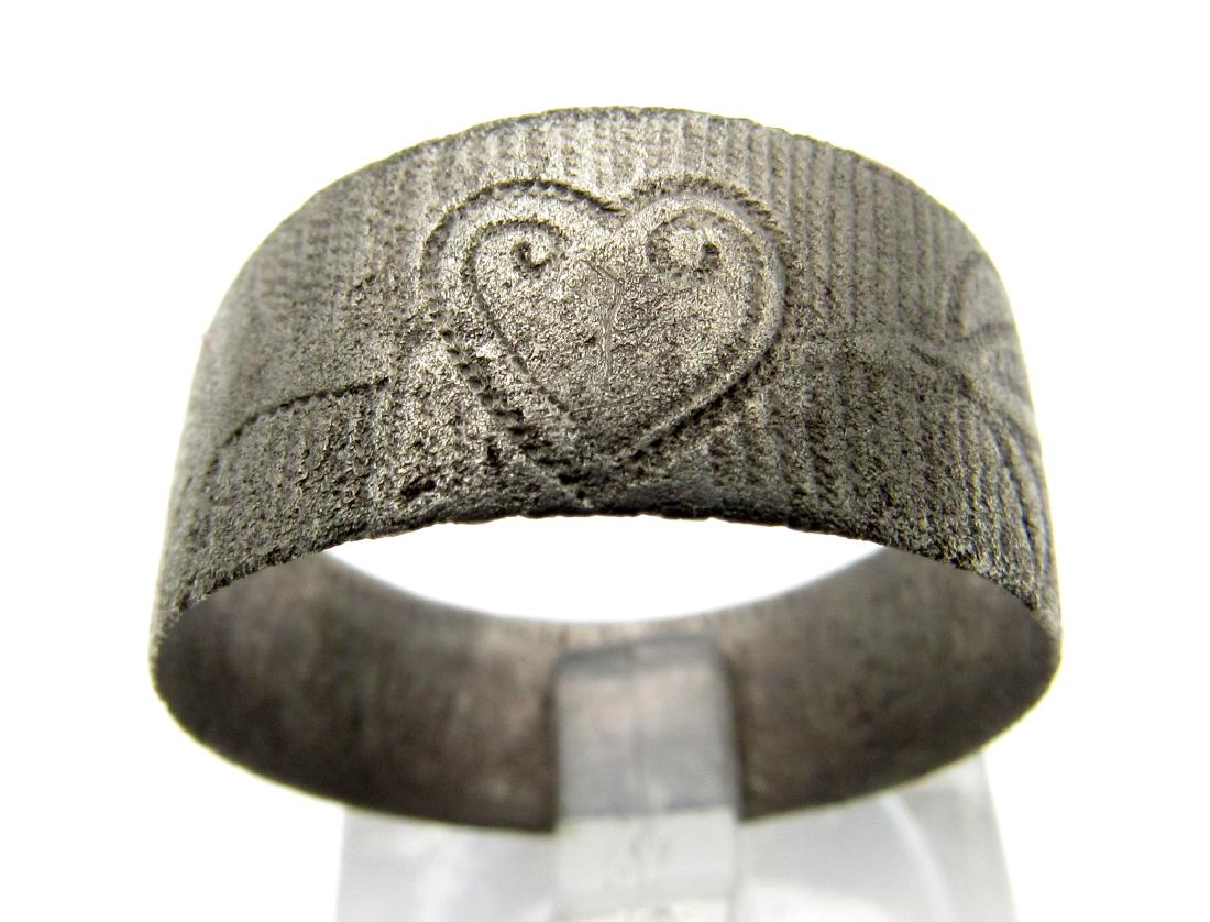 Antique Silver Ring Decorated with a Heart: Date: 1920 Material: silver Provenance: Obtained from an old British collection, acquired from the B.C.F. (Birmingham) Dimensions: 19mm; 2.2grams Antique Silver Ring Decorated with a Heart, engraved w
