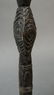 This dark paddle handle has design/ clan motifs on the - 2